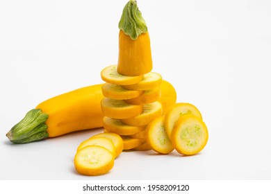 Whole And Sliced Pieces Of Summer Squash Zucchini, Yellow Colored Gourd Also Known As Courgette, Baby Marrow, Indian Jugni Sabzi Or Jugnu Petha Sabji Decorated On White Background With Copy Space