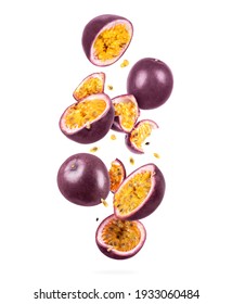 Whole and sliced ripe passion fruit in the air, isolated on a white background