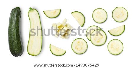 Whole and sliced zucchini isolated on white background. Top view.
