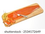 A whole smoked salmon fillet on a cutting board isolated on white background, accurate clipping path embedded.

