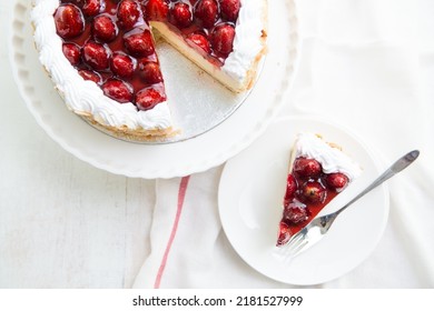 Whole Strawberry cheesecake with slice of cake on the plate set on the table - Shutterstock ID 2181527999