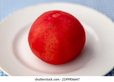 Whole Tomato Without Peel On A White Earthenware Plate