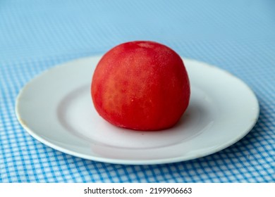 Whole Tomato Without Peel On A White Earthenware Plate