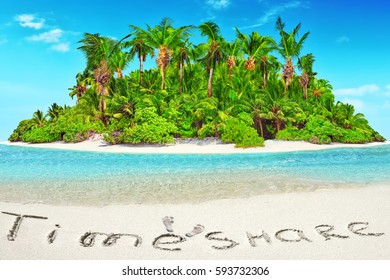 Whole tropical island within atoll in tropical Ocean. Uninhabited and wild subtropical isle with palm trees. Inscription "TimeShare" in the sand on a tropical island,  Maldives.