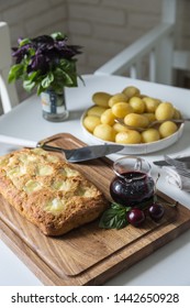 The Whole Veal Meatloaf With Mozzarella, Berry Sauce And Baby Potatoes In Caramel Dressing On White Kitchen.