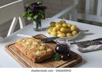 The Whole Veal Meatloaf With Mozzarella, Berry Sauce And Baby Potatoes In Caramel Dressing On White Kitchen.