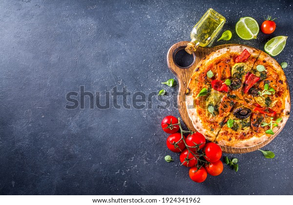 Whole Vegan\
Homemade pizza. Whole Grain Pizza with baked Vegetables and\
Mushrooms. grey stone background copy\
space