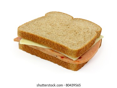 A Whole Wheat Bread Sandwich With Pickle And Pimento And Pepper Jack Cheese On A White Background.