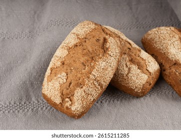 Whole wheat brown bread, fitness pumpkin carrot buns with seeds, cereal bread grain bun with rye on rustic background