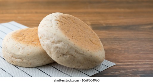 Whole wheat english muffins  on rustic wooden background. copy space. - Powered by Shutterstock