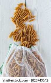 Whole Wheat Macaroni Spilling From A Cloth Bag. Overhead View