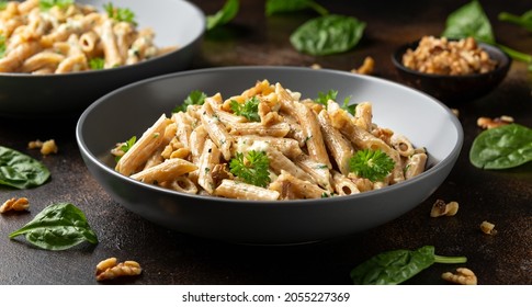 Whole Wheat Penne pasta with gorgonzola cheese sauce, spinach and walnut. Healthy food. - Powered by Shutterstock