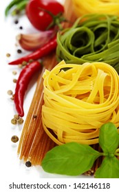 whole wheat spaghetti and egg pasta nests over white