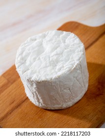 Whole Wheel Of Delicate Blue Cheese Served On Wooden Cutting Board