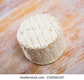 Whole Wheel Of Piquant Creamy Blue Cheese On Wooden Surface