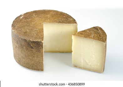 Whole Wheel Of Sheep Milk Cheese Over White Background.