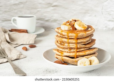 Wholegrain pancakes with banana and caramel sauce. Delicious breakfast.