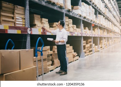 Wholesale, logistic, business, export and people concept - Man warehouse worker checking goods at warehouse.