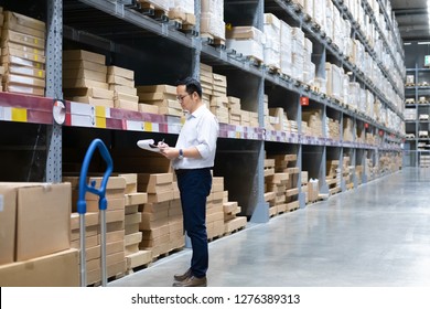 Wholesale, logistic, business, export and people concept - Man warehouse worker checking goods at warehouse. 