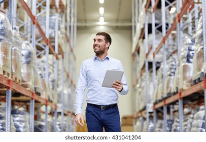 Wholesale, Logistic, Business, Export And People Concept - Happy Man Or Manager With Tablet Pc Computer Checking Goods At Warehouse