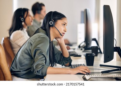 Why does this webpage always take forever to load. Shot of a young call centre agent looking bored while working on a computer in an office. - Shutterstock ID 2170157541