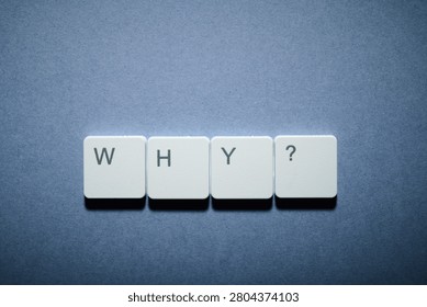 Why question text written witk white keys of a keyboard on a gray table
