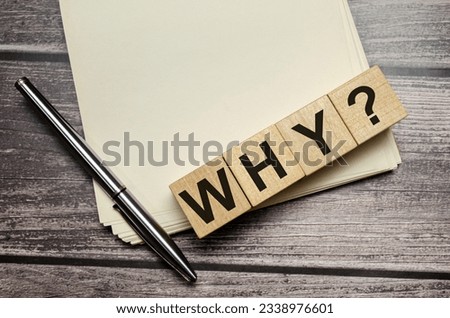 why Word Written In Wooden Cubes on notebook with pen