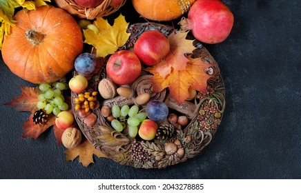 Wiccan Altar For Mabon Sabbat. Fruits, Pumpkins, Leaves, Nuts, Wheel Of The Year On Black Background. Pagan, Wiccan Traditions. Witchcraft, Esoteric Spiritual Ritual. Autumn Equinox Holiday