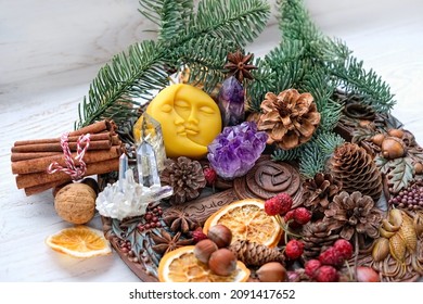 Wiccan altar for Yule holiday. wheel of the year with amulet, gemstones, cinnamon, nuts, cones, dry orange slices on table. spiritual Esoteric Ritual for Yule, Magical Winter Solstice. witchcraft