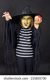 Wicked Witch Offering Poisoned Apple, Kid In Halloween Costume