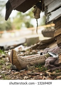 Wicked Witch Of The West (from The Wizard Of Oz) Sticking Out From Under House Destroyed By A Tornado.