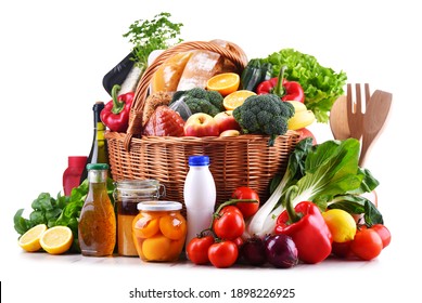 Wicker basket with assorted grocery products including fresh vegetables and fruits - Shutterstock ID 1898226925