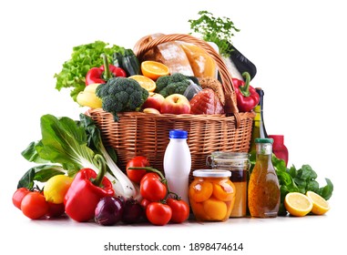 Wicker basket with assorted grocery products including fresh vegetables and fruits - Shutterstock ID 1898474614
