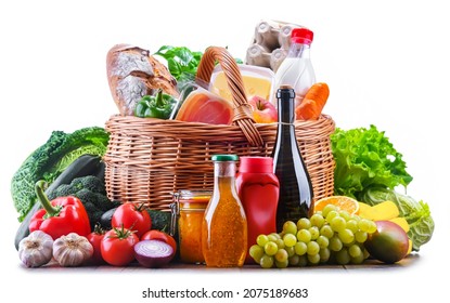 Wicker basket with assorted grocery products including fresh vegetables and fruits - Shutterstock ID 2075189683