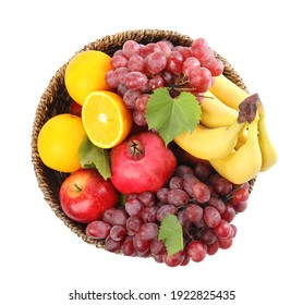 Wicker basket with different fruits on white background, top view