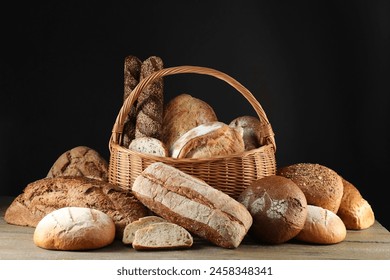 Wicker basket with different types of fresh bread on wooden table - Powered by Shutterstock