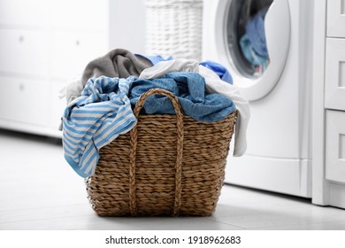 Wicker Basket With Dirty Laundry On Floor Indoors