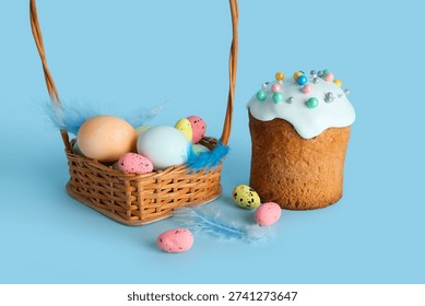 Wicker basket, Easter eggs and cake on blue background