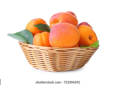 Wicker basket with fresh apricots on white background - Powered by Shutterstock