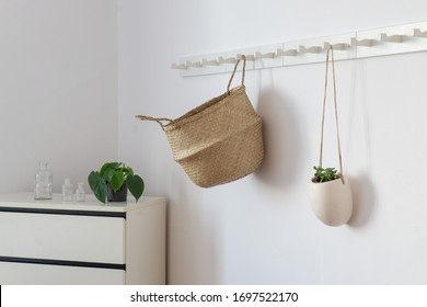 
wicker basket on coat-rack with hanging plant - Powered by Shutterstock