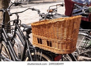 Wicker basket on de back of a parked bicycle to be used to transport or carry a dog or other pets along the ride in The Netherlands. Typical Dutch way of traveling on a sunny summer day - Powered by Shutterstock