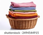 Wicker basket with a stack of colorful  clothes on a white background. Clean, folded, stacked colorful blue, pink, white, green, lilac,  yellow, orange, clothes in a wicker basket isolated.