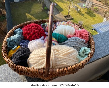 wicker basket with stash yarn of super chunky wool and yarn photographed outdoors