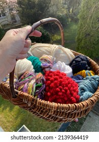 wicker basket with stash yarn of super chunky wool and yarn photographed outdoors