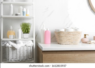 Wicker basket with toilet paper rolls on countertop in bathroom - Shutterstock ID 1612815937