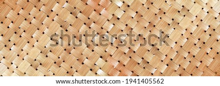 wicker basket or woven basket texture and pattern, Bamboo woven textured, detail handcraft bamboo weaving texture backgrounds, with yellowed colors natural. applicable backgrounds banner, wallpaper. 