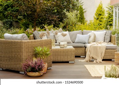 Wicker furniture on a wooden terrace of modern house