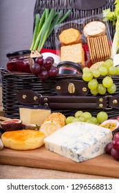 Wicker Hamper With Cheese Pickles And Crackers.