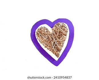 Wicker heart made of wood inside a drawn purple heart, isolated on a white background. Idea for decorating a wall in a house. Handmade for home interior designers. Top view. - Powered by Shutterstock