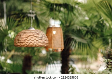 Wicker lampshade in an outdoor street cafe. Vintage decorative